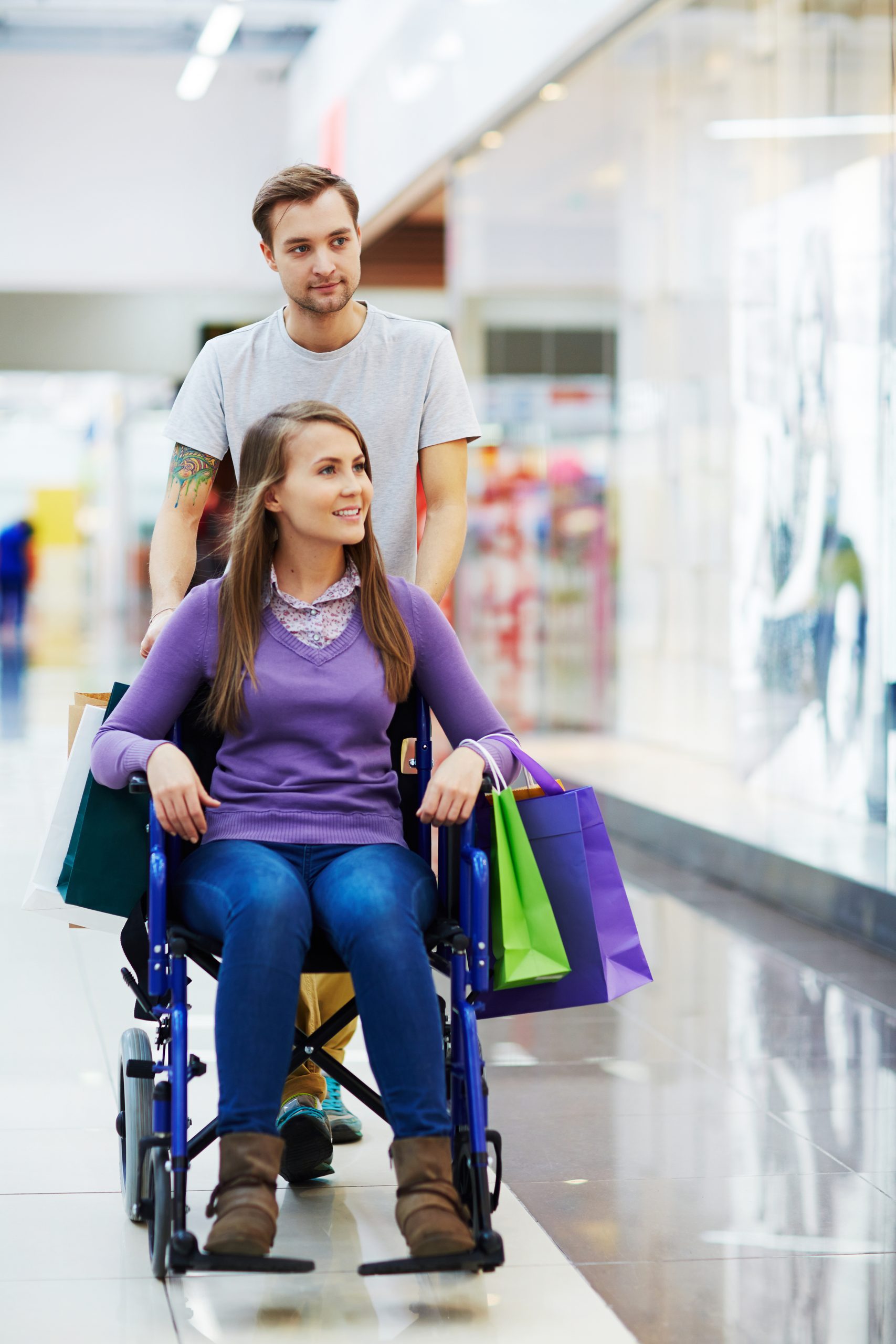 one person pushing another in a wheelchair